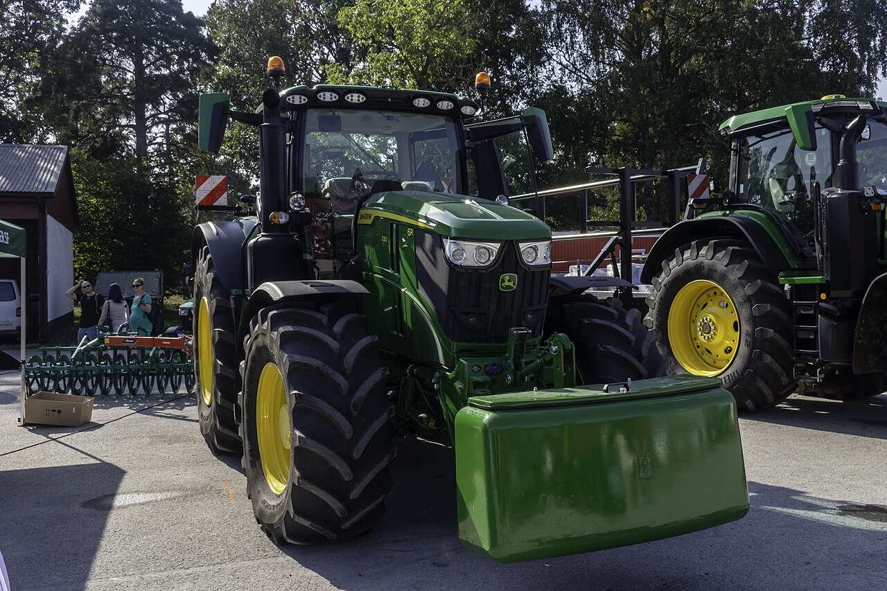 John Deere 6R 230 med frontvikt vid en maskinvisning.